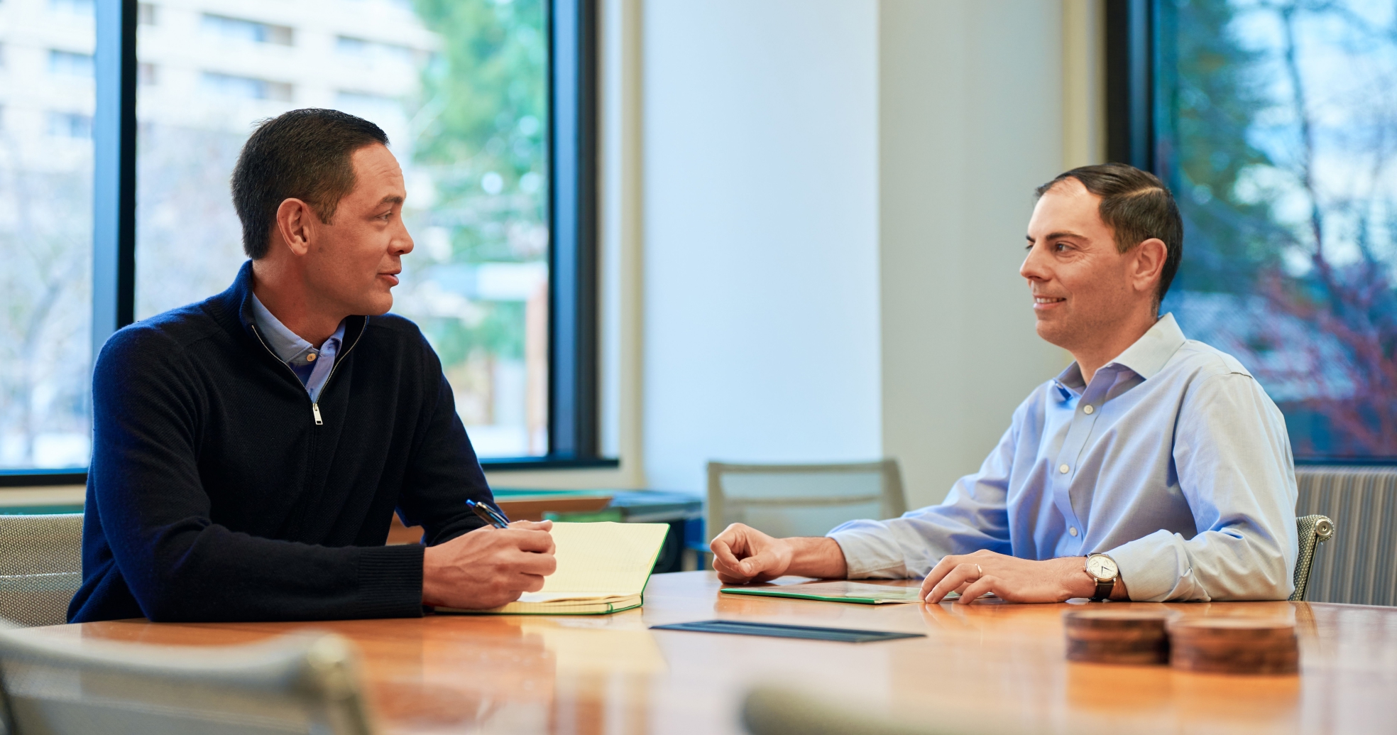 Two colleagues having a business discussion in a conference room
