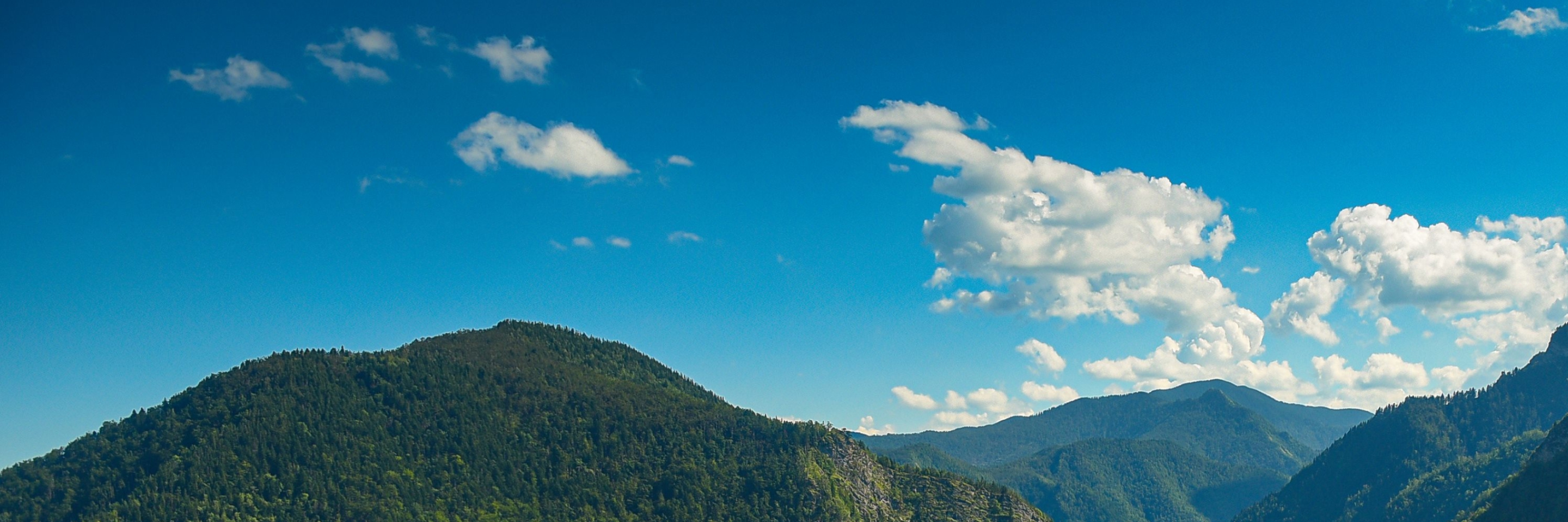 Mountain landscape under a blue sky with scattered clouds